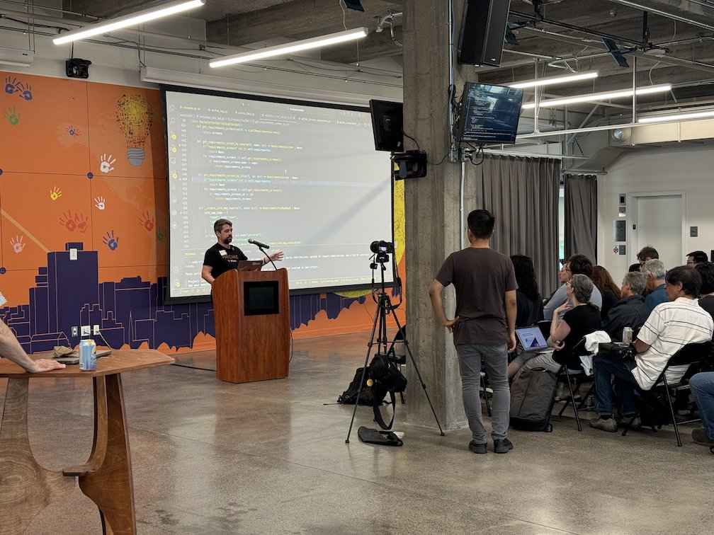 A talk with VSCode open and a camera on a tripod recording it.