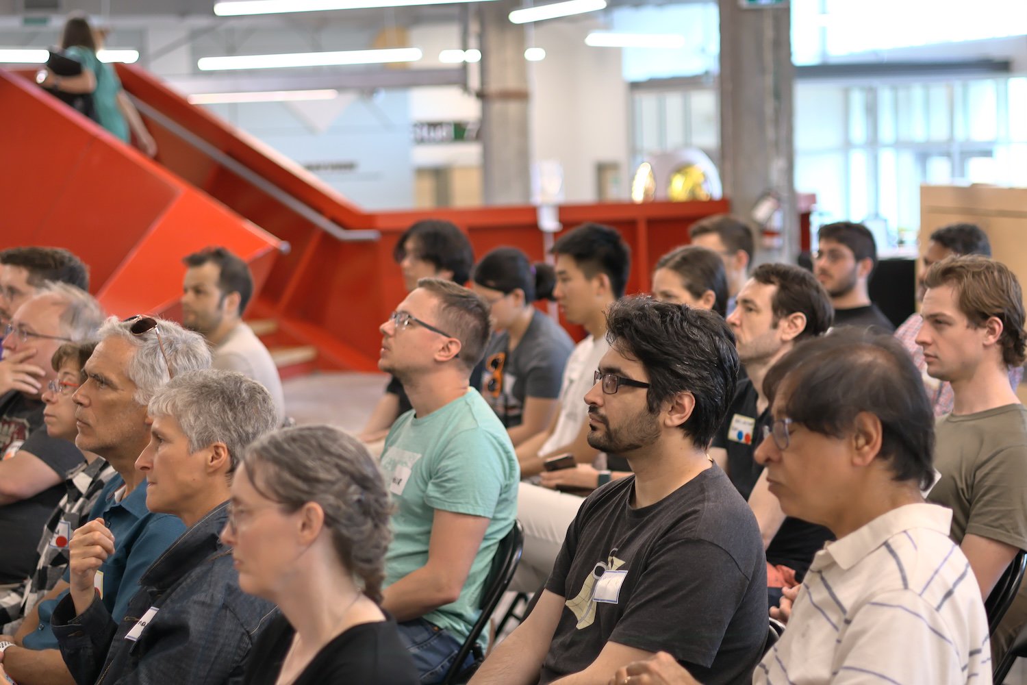 A group of people looking at one of the talks, genuinely interested.