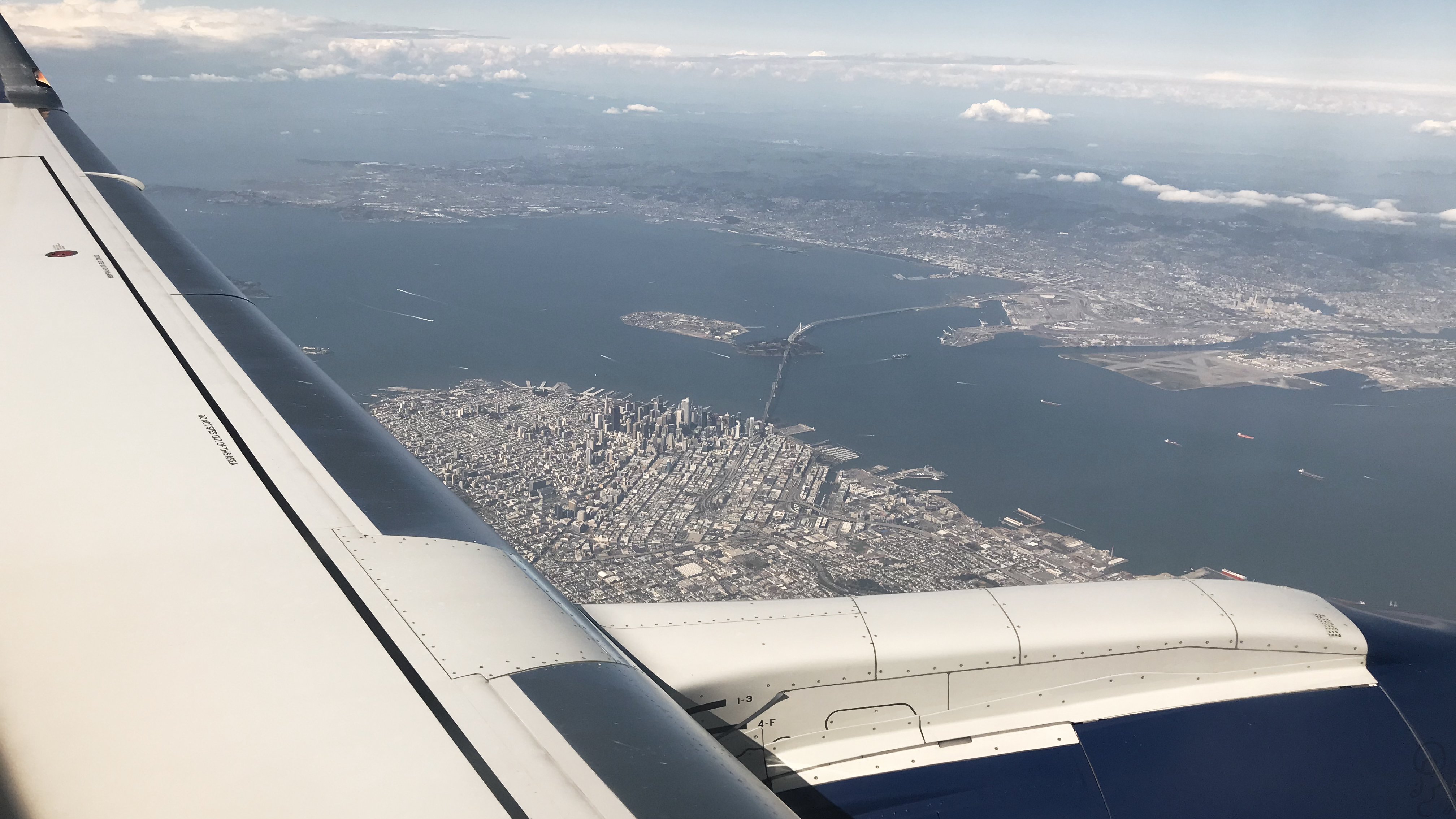 An image of An airplane above San Francisco, right as it's circling around to land
